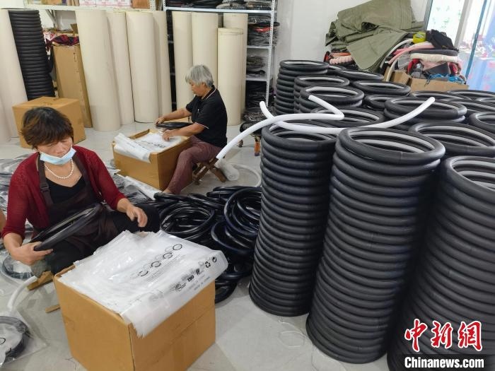 圖為村民在汽車飾品企業(yè)生產(chǎn)車間中工作?！巫雍?攝