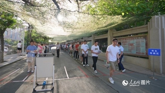 6月7日，烏魯木齊市第七十中學門口，考生們有序進入考場。人民網 李欣洋攝