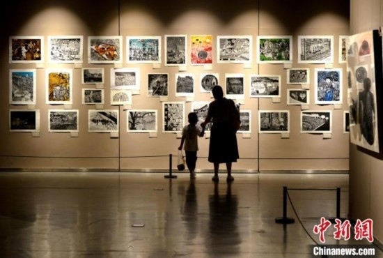 圖為家長帶著孩子參觀展覽。呂明 攝