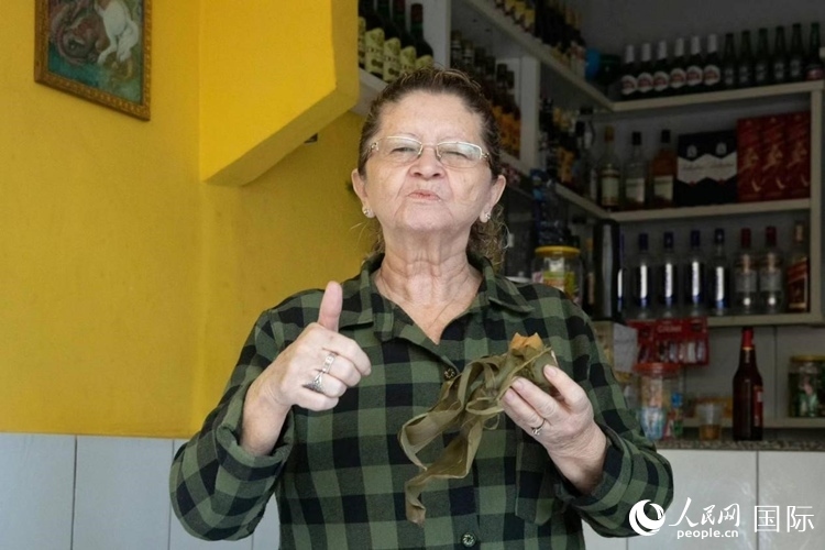 圣瑪塔社區(qū)居民品嘗粽子。王天聰攝