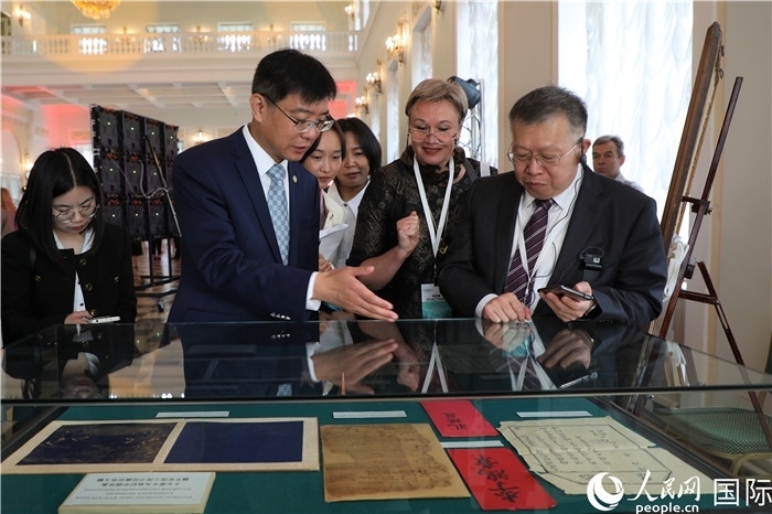 中俄圖書館論壇嘉賓共同參觀由俄羅斯國立列寧圖書館舉辦的館藏中國古籍善本圖書展。人民網(wǎng)記者 隋鑫攝）