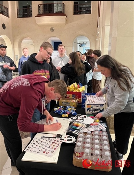 學生們出發(fā)前紛紛在留言簿留言。人民網(wǎng)記者 鄧圩攝