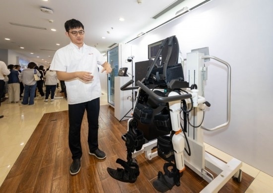 2024年5月24日，在位于上海市嘉定區(qū)的上海交通大學醫(yī)學院附屬瑞金醫(yī)院腫瘤質(zhì)子中心，工作人員介紹由瑞金醫(yī)院醫(yī)生和醫(yī)療公司共同研發(fā)的用于恢復患者下肢的醫(yī)療機器人。新華社記者 王翔 攝