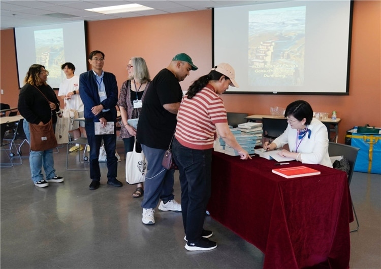 作者顧春芳在活動(dòng)現(xiàn)場(chǎng)簽名贈(zèng)書。羅先勇攝