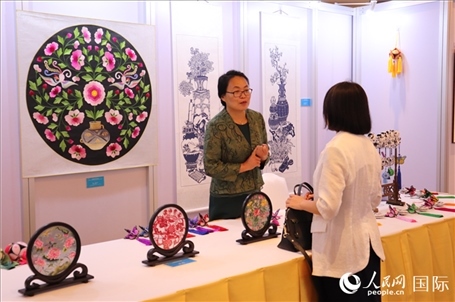 青海非遺文化傳承人向嘉賓介紹展品。人民網(wǎng)實習生姚欣可攝