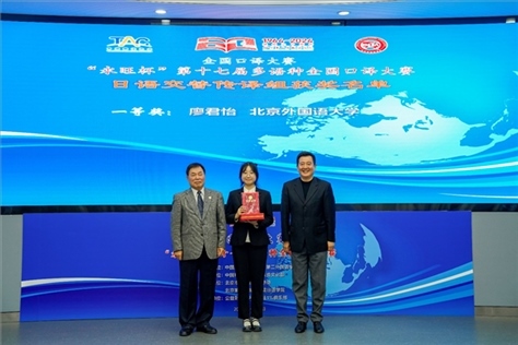 中國翻譯協(xié)會副會長中國外文局中東歐與中南亞傳播中心（人民畫報社）主任姜永鋼（右一）、原中國教育工會全國委員會巡視員白立文（左一）為獲得日語交傳組一等獎的北京外國語大學廖君怡頒獎（主辦方提供）