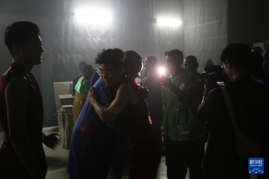 4月10日，在塞內(nèi)加爾首都達(dá)喀爾的國家大劇院，中央音樂學(xué)院進(jìn)擊打擊樂團(tuán)成員與塞內(nèi)加爾杜杜·恩迪亞耶·羅斯打擊樂團(tuán)成員在演出后臺(tái)擁抱。新華社記者 司源 攝